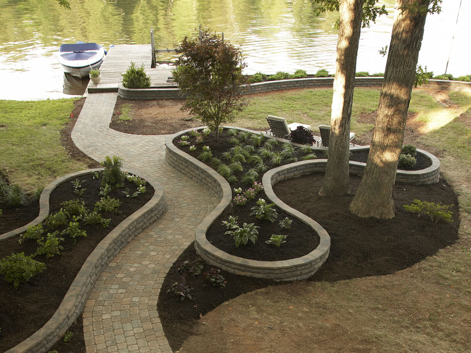 Lakeside abstract raised planters made with ChiselWall retaining walls flanking a paver stone walkway